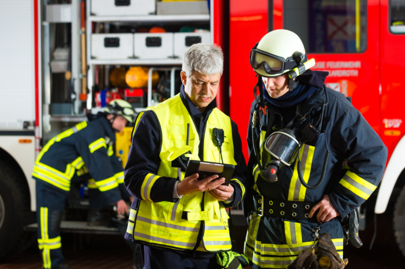 Two firefighters coordinate
