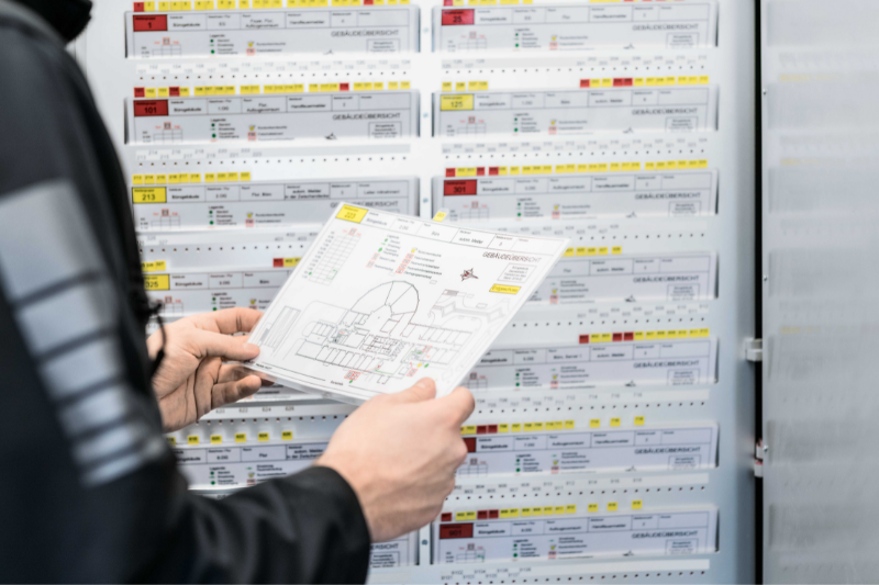A fire brigade running card is held in the hands