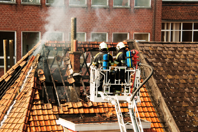 Two firefighters on a turntable ladder in action
